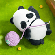Cat’s Ball design: panda lying on grass playing with a lilac wool ball – Panda Roll Blind Box figure

