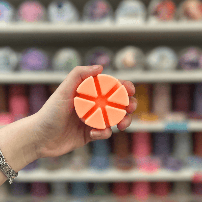 Peach Bellini peach segmented wax melt held in hand