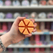 Peanut Butter Cookie wax melt segments held in hand with colourful wax melt display in the background