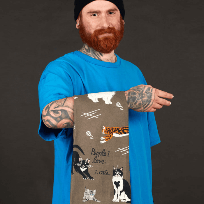 Model holding grey cat tea towel with People I love: cats text.
