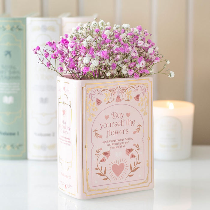 Pink ceramic book shaped vase with flowers for bookish home decor
