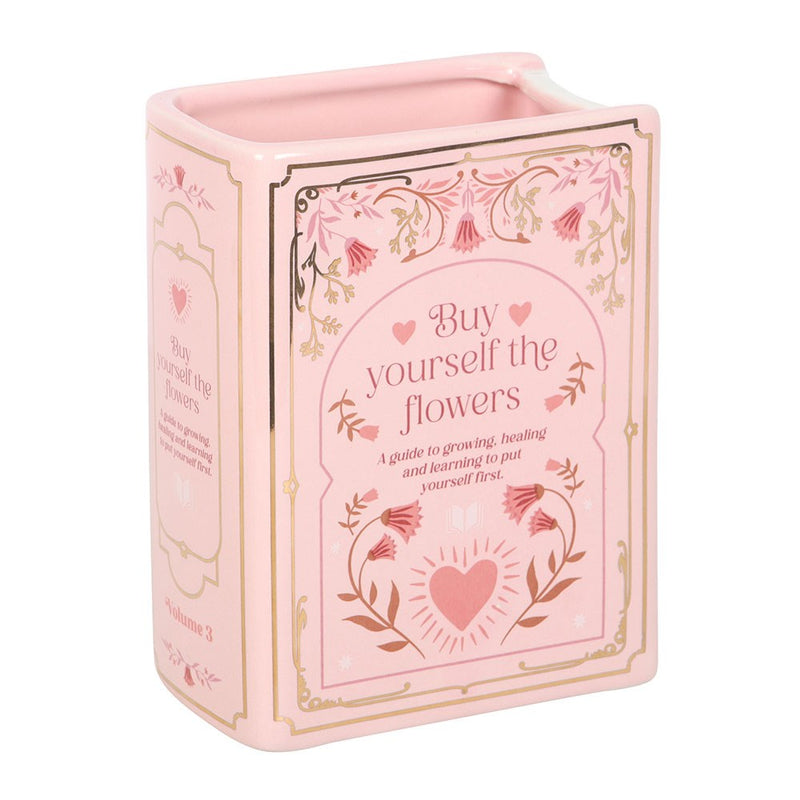 Pink ceramic book vase with Buy Yourself the Flowers cover design