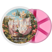 Pink Petal Linens wax melt pot with six pink segments and floral laundry-day label