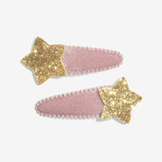 Pair of pink velvet snap hair clips topped with chunky gold glitter stars
