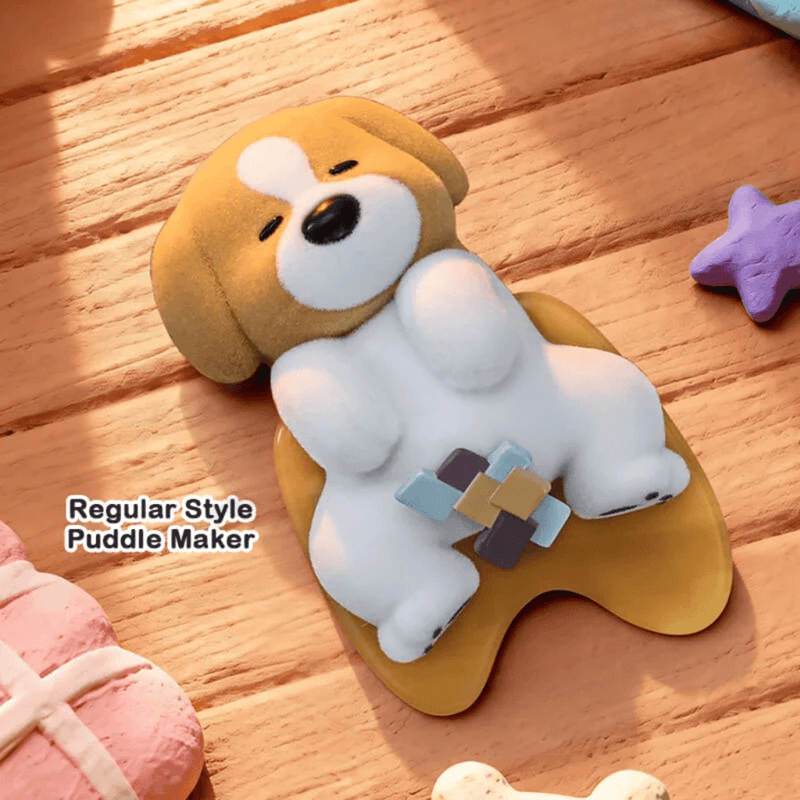 Puddle Maker dog figure from the 52TOYS PooPoo Pups Series lying on its back