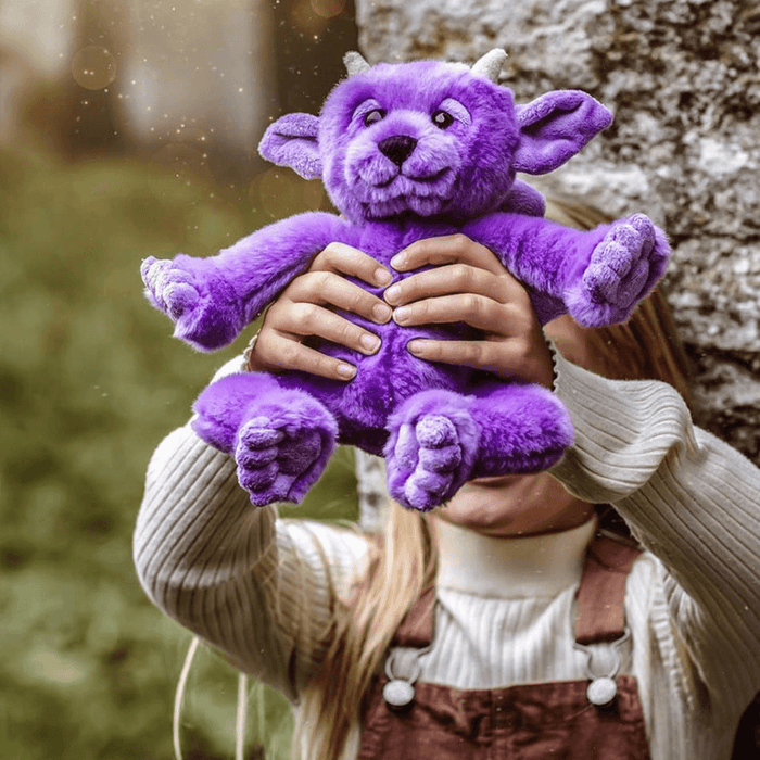 Portcullis Bearhouse by Charlie Bears purple plush gargoyle toy held in hands, cosy lifestyle photo outdoors
