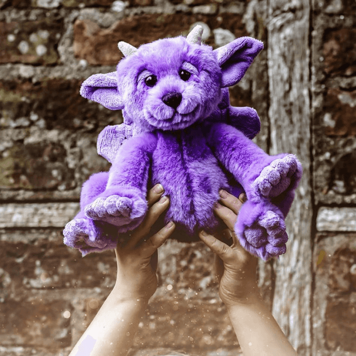 Portcullis by Charlie Bears Bearhouse purple gargoyle plush held up outdoors, showing the soft fur and wings