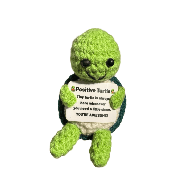 Crochet green Positive Turtle decoration holding a motivational message card on white background