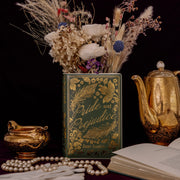 Pride and Prejudice book vase styled with dried flowers beside vintage gold teaware.