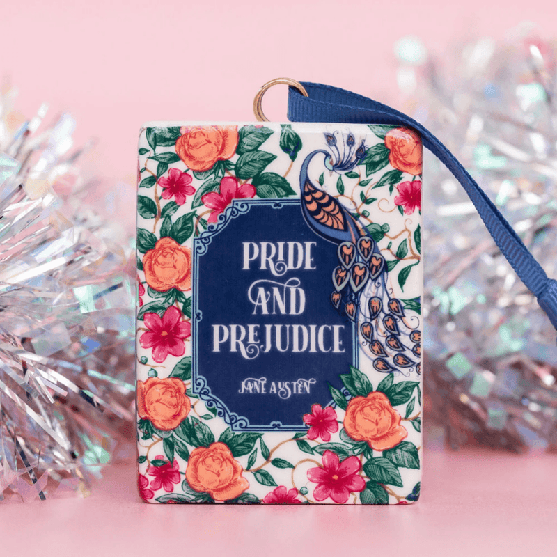 Pride and Prejudice Christmas ornament with blue ribbon in a festive display