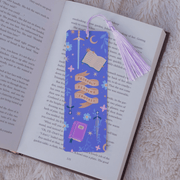 Probably Reading Fantasy bookmark marking a page inside an open book