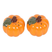 Angled top view of pumpkin shakers highlighting the sprinkle holes for salt and pepper.

