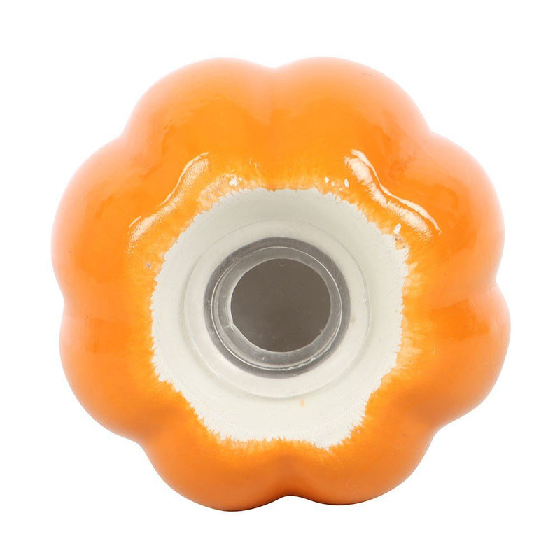 Underside of a pumpkin shaker displaying the removable rubber stopper for easy refilling.

