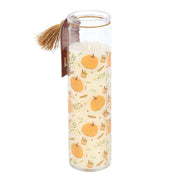 Angled shot of slim pumpkin-patterned tube candle showing wick depth.
