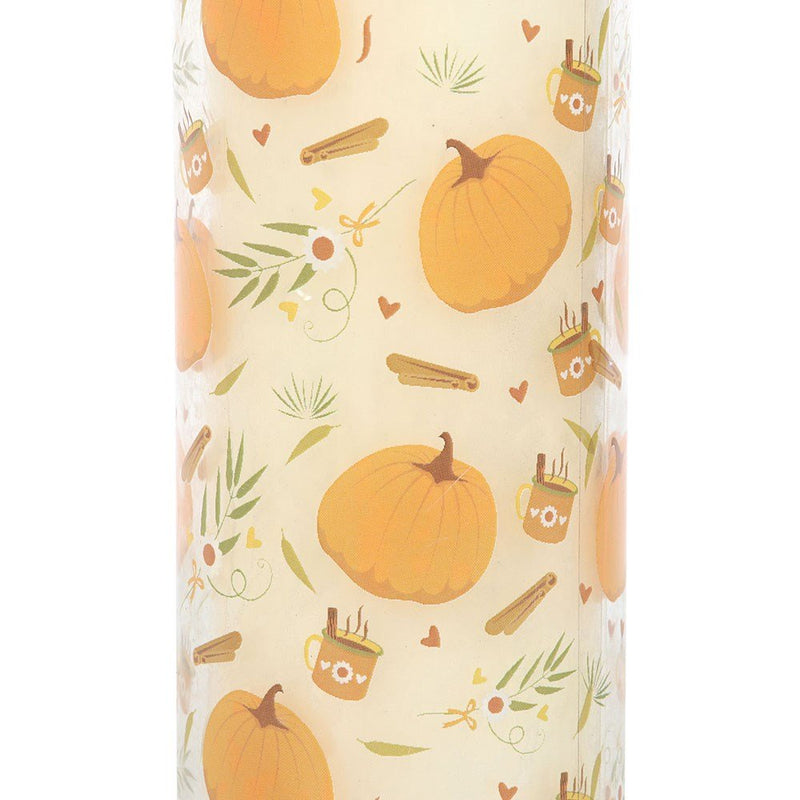 Close-up of pumpkin, cinnamon and mug motifs printed on the candle’s glass sleeve.

