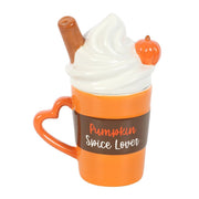 Front view of orange Pumpkin Spice Lover ceramic mug with white swirl lid and heart handle.
