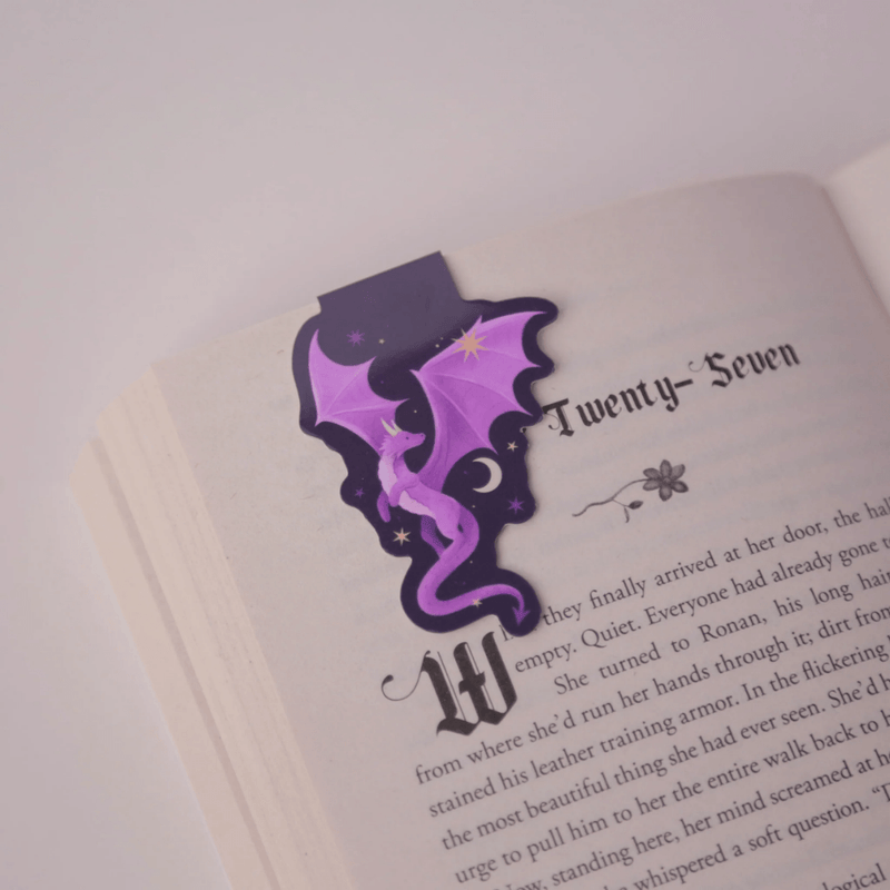 Purple Dragon magnetic bookmark clipped securely over a book page