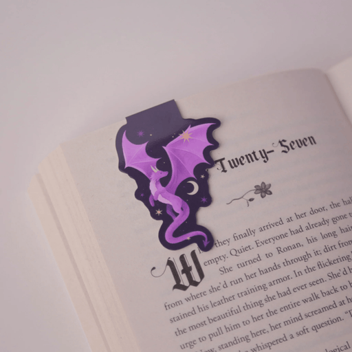 Purple Dragon magnetic bookmark clipped securely over a book page