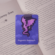 Purple Dragon magnetic bookmark clipped over the page of an open book