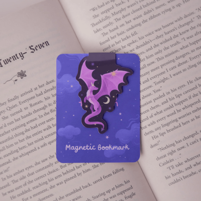 Purple Dragon magnetic bookmark clipped over the page of an open book