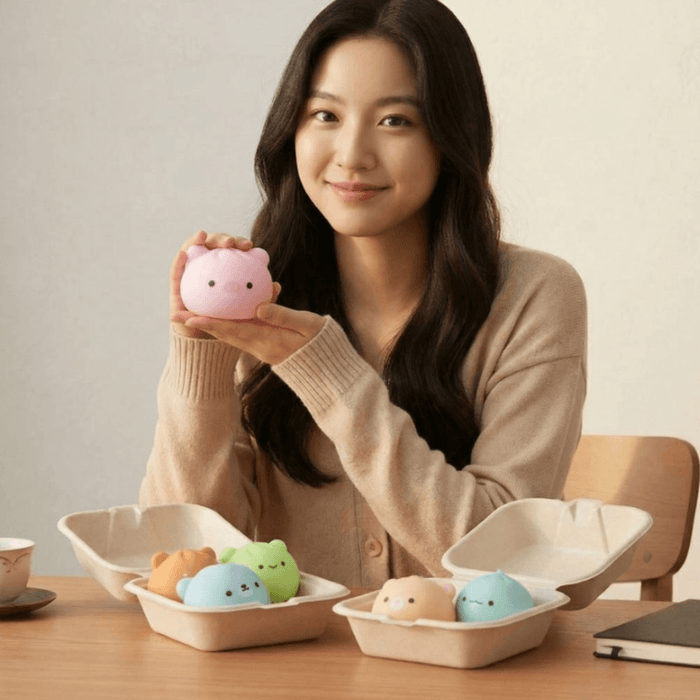Person holding a pink animal dumpling squishy from the blind box collection