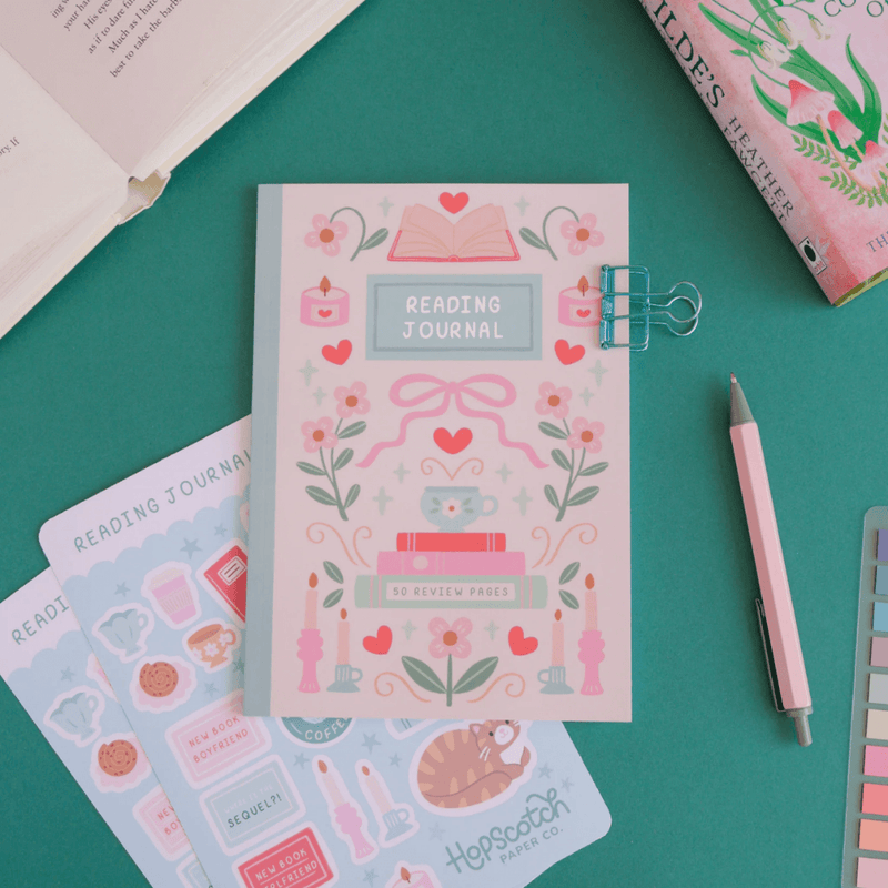 Reading Journal flat lay with stickers, pen and books
