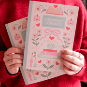 Hopscotch Paper Co. Reading Journal held in both hands