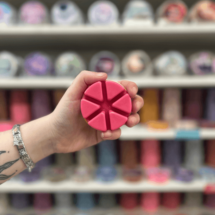 Rhubarb and Custard pink segmented wax melt held in hand