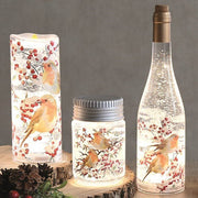 Group scene showing robin-themed LED water spinner glowing beside matching pieces on wooden slices.