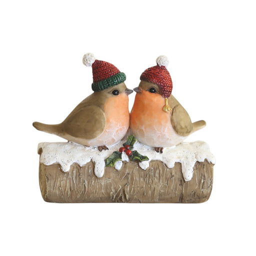 Two robins in bobble hats on a snowy log with holly, 11.5cm ornament.

