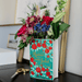 Romeo and Juliet ceramic book vase filled with flowers on a dressing table