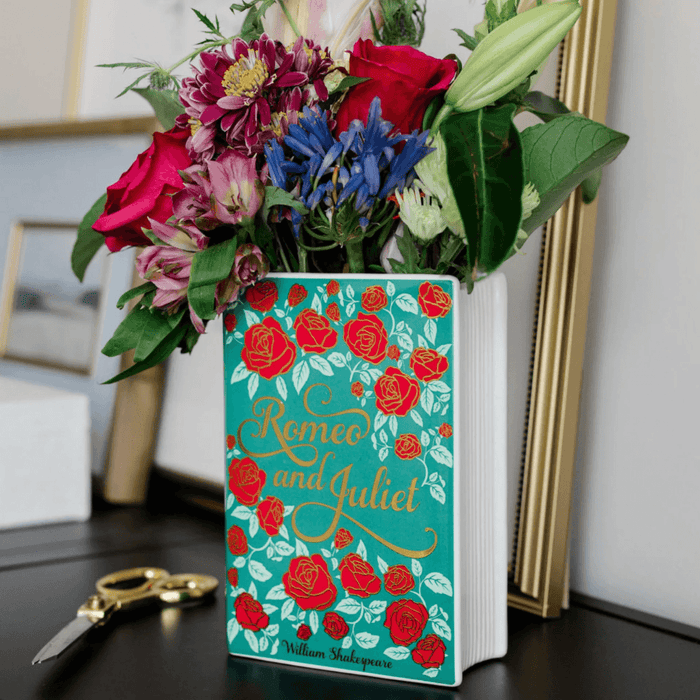 Close up of the Romeo and Juliet ceramic book vase filled with colourful flowers