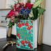 Close up of the Romeo and Juliet ceramic book vase filled with colourful flowers