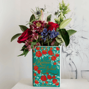 Romeo and Juliet ceramic book vase used as a decorative flower arrangement