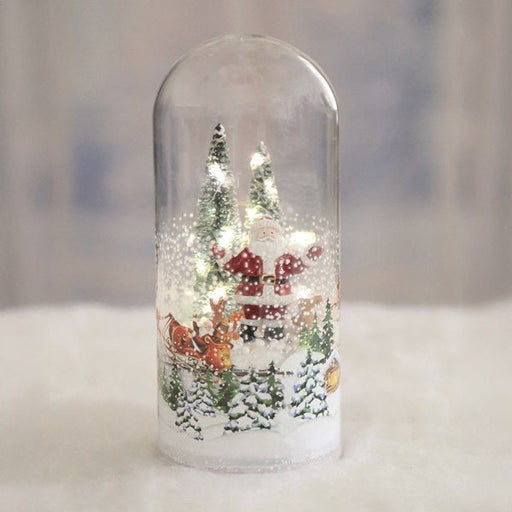Santa scene glass dome with LEDs glowing, 21cm, lifestyle display.

