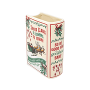 Angled reverse view of Santa Christmas book vase showing the sleigh illustration, decorated spine and open ceramic top