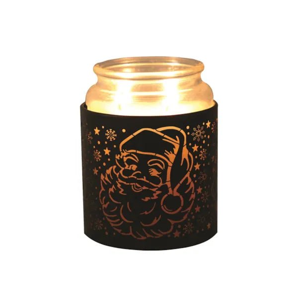 Black Santa silhouette sleeve used as a candle jar holder with lit jar inside