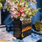 Angled view of Feyre’s Dresser Vase showing the painted drawers and printed passage