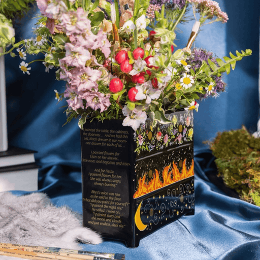 Angled view of Feyre’s Dresser Vase showing the painted drawers and printed passage