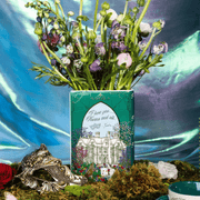 Back of the Spring Court book vase filled with flowers and featuring Tamlin’s manor artwork