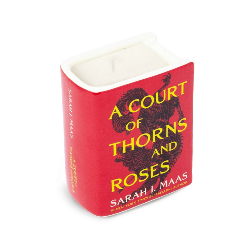 Angled front view of A Court of Thorns and Roses ceramic candle showing red cover and single wick