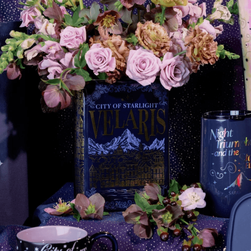 Sarah J Maas Velaris book flower vase filled with flowers in a Night Court display