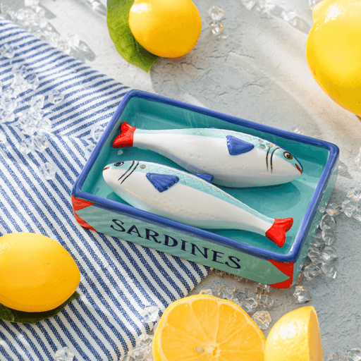 Sardine salt and pepper shakers styled with lemons and striped table linen