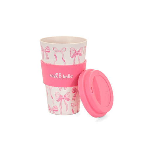 Sass & Belle bow travel coffee cup with lid placed beside it on a white background