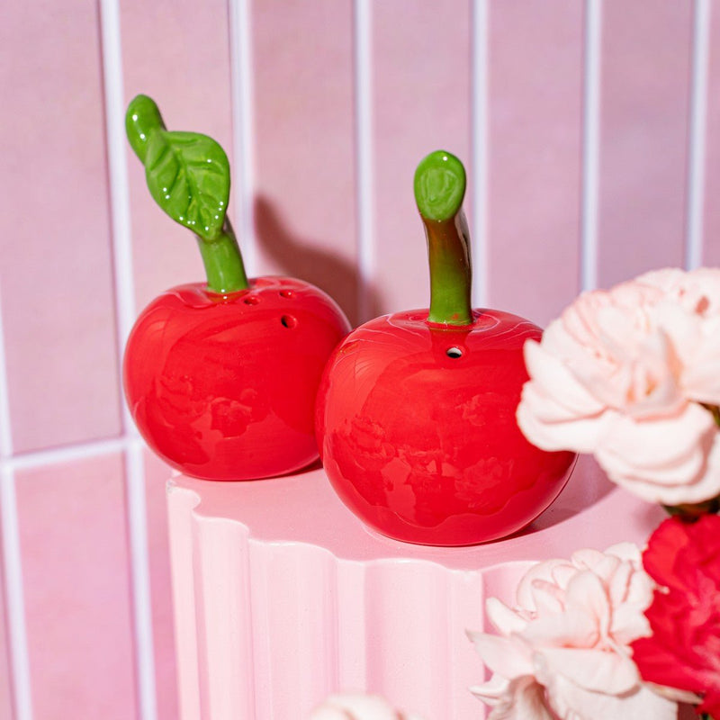 Close-up of Sass & Belle Cherry salt and pepper shakers, glossy red ceramic