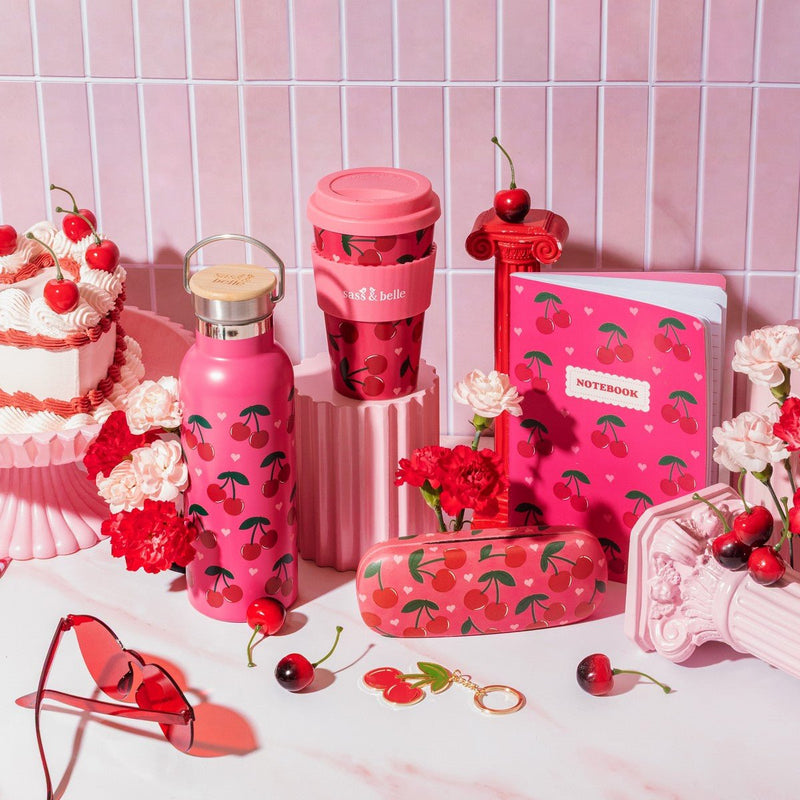 Cherry print travel cup styled with matching cherry stationery and accessories