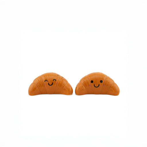 Sass & Belle Croissant salt and pepper shakers, front view with smiling faces