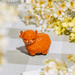 Highland Cow pocket token on a gingham cloth with flowers in the background