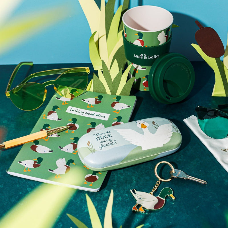 Mallard duck travel coffee cup styled with matching duck-themed stationery and accessories