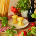 Sass & Belle pasta farfalle salt and pepper shakers on a plate with herbs and tomatoes